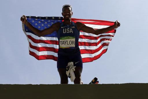 United States' Christian Taylor celebrates with the U.S. flag after winning the gold medal in the men's triple jump final during the athletics competitions of the 2016 Summer Olympics at the Olympic stadium in Rio de Janeiro, Brazil, Tuesday, Aug. 16, 2016. (AP Photo/Charlie Riedel)