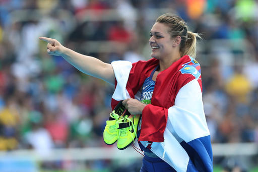 Croatia's Sandra Perkovic celebrates winning the gold medal in the women's discus throw during the athletics competitions of the 2016 Summer Olympics at the Olympic stadium in Rio de Janeiro, Brazil, Tuesday, Aug. 16, 2016. (AP Photo/Lee Jin-man)