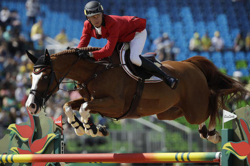 Belgium's Jerome Guery, riding Grand Cru Van De Roz, competes in the equestrian jumping competition at the 2016 Summer Olympics in Rio de Janeiro, Brazil, Tuesday, Aug. 16, 2016. (AP Photo/John Locher)