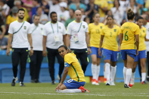 Brazil's Marta, front, reacts after a penalty shootout during a semifinal match of the women's Olympic football tournament between Brazil and Sweden at the Maracana stadium in Rio de Janeiro Aug. 16, 2016. Sweden qualified for the final after beating Brazil on penalty kicks. (AP Photo/Silvia Izquierdo)