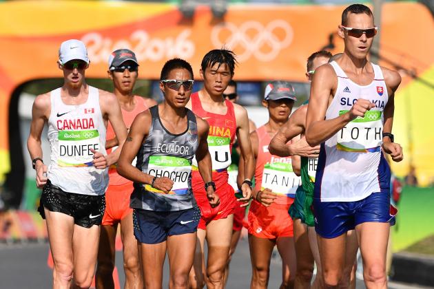 Canada's Evan Dunfee, Ecuador's Andres Chocho, China's Yu Wei and Slovakia's Matej Toth compete in the Men's 50km Race Walk during the athletics event at the Rio 2016 Olympic Games in Pontal in Rio de Janeiro on August 19, 2016.   / AFP / Jewel SAMAD        (Photo credit should read JEWEL SAMAD/AFP/Getty Images)
