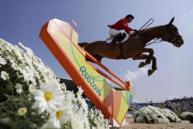 Germany's Daniel Deusser, riding First Class, competes during the equestrian individual jumping competition at the 2016 Summer Olympics in Rio de Janeiro, Brazil, Friday, Aug. 19, 2016. (AP Photo/John Locher)