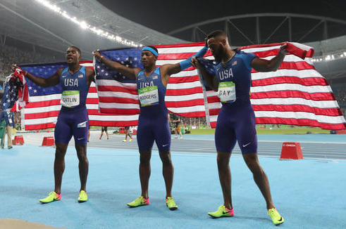 Members of the United States team from left, United States' Justin Gatlin, United States' Mike Rodgers and United States' Tyson Gay celebrate after the men's 4x100-meter relay final during the athletics competitions of the 2016 Summer Olympics at the Olympic stadium in Rio de Janeiro, Brazil, Friday, Aug. 19, 2016. (AP Photo/Lee Jin-man)