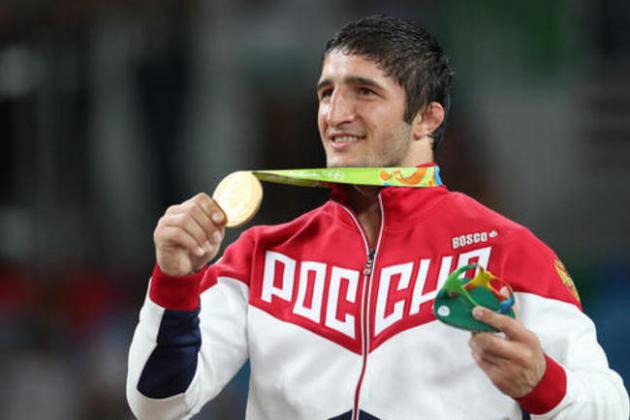 Russia's Abdulrashid Sadulaev displays his gold medal after winning the men's 86-kg freestyle wrestling competition at the 2016 Summer Olympics in Rio de Janeiro, Brazil, Saturday, Aug. 20, 2016. (AP Photo/Petr David Josek)