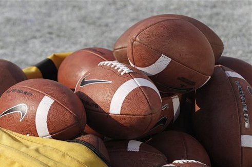 A bag of footballs sits on the field before the start of the Oklahoma-Kansas State NCAA college football game in Norman, Okla., Saturday, Sept. 22, 2012. (AP Photo/Sue Ogrocki)