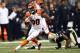 NEW ORLEANS, LA - NOVEMBER 16: Cedric Peerman #30 of the Cincinnati Bengals avoids a tackle by Corey White #24 of the New Orleans Saints during a game at the Mercedes-Benz Superdome on November 16, 2014 in New Orleans, Louisiana. Cincinnati defeated New Orleans 27-10. (Photo by Stacy Revere/Getty Images)