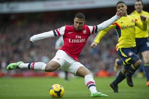 Arsenal's Serge Gnabry tries to score past Sunderland's Liam Bridcutt during their English Premier League soccer match, at Emirates Stadium, in London, Saturday, Feb. 22, 2014. (AP Photo/Bogdan Maran)