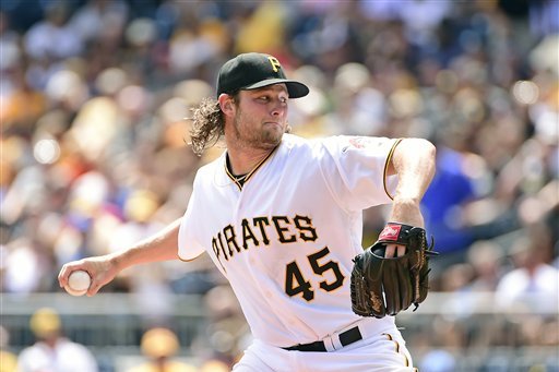 Pitcher Gerrit Cole of the Pittsburgh Pirates rests on the bench