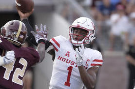 Houston quarterback Greg Ward, Jr., throws the ball over Texas State defenders during the first half of an NCAA college football game, Saturday, Sept. 24, 2016, in San Marcos, Texas. (AP Photo/Darren Abate)