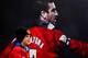 A young fan alongside a picture of Eric Cantona.