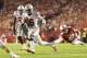 Oct 15, 2016; Madison, WI, USA; Ohio State Buckeyes quarterback J.T. Barrett (16) rushes with the football as Wisconsin Badgers linebacker T.J. Watt (42) dives from behind during the fourth quarter at Camp Randall Stadium. Ohio State won 30-23. Mandatory Credit: Jeff Hanisch-USA TODAY Sports