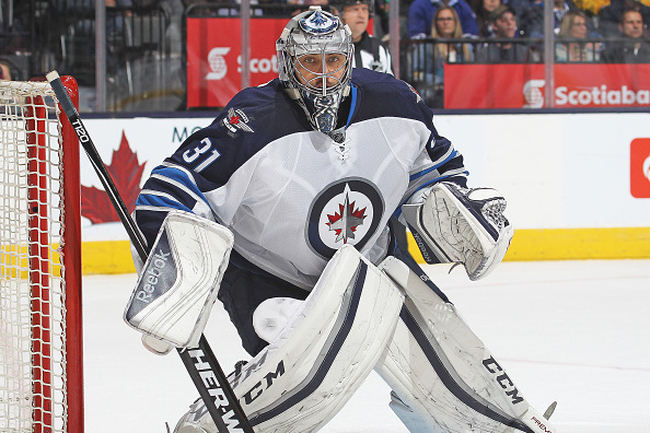 Winnipeg Jets goaltender Ondrej Pavelec (31) is hit in the mask by