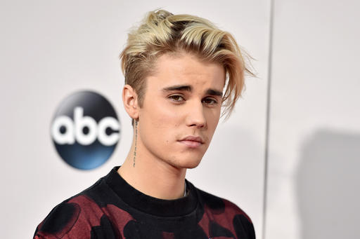 FILE - In this Nov. 22, 2015 file photo, Justin Bieber arrives at the American Music Awards at the Microsoft Theater in Los Angeles. Bieber has returned to Instagram two weeks after disappearing from the photo sharing platform after getting negative comments from fans of ex-girlfriend Selena Gomez. (Photo by Jordan Strauss/Invision/AP, File)