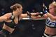 Ronda Rousey of the US (L) lines up compatriot Holly Holm (R) during the UFC title fight in Melbourne on November 15, 2015. RESTRICTED TO EDITORIAL USE NO ADVERTISING USE NO PROMOTIONAL USE NO MERCHANDISING USE. AFP PHOTO/Paul CROCK (Photo credit should read PAUL CROCK/AFP/Getty Images)