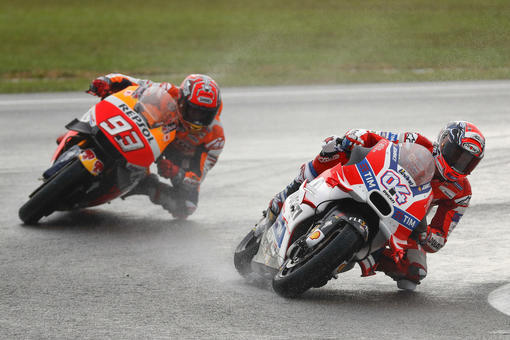 Ducati MotoGP rider Andrea Dovizioso, right, of Italy, enters a curve, followed by Honda MotoGP rider Marc Marquez of Spain during the Malaysian Motorcycle Grand Prix in Sepang, Malaysia, Sunday, Oct. 30, 2016. Dovisioso won the race while Marquez finished 11th. (AP Photo/Vincent Thian)