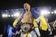 Vasyl Lomachenko, of Ukraine, poses for photographs with the WBO junior lightweight belt after a boxing match against Roman Martinez, of Puerto Rico, Saturday, June 11, 2016, in New York. Lomachenko stopped Martinez in the fifth round.(AP Photo/Frank Franklin II)