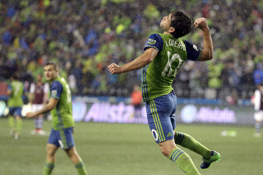 Seattle Sounders forward Nicolas Lodeiro, right, celebrates near forward Jordan Morris, left, after Lodeiro scored a goal against the Colorado Rapids in the second half of the first leg of the MLS soccer Western Conference championship, Tuesday, Nov. 22, 2016, in Seattle. The Sounders beat the Rapids 2-1.(AP Photo/Ted S. Warren)