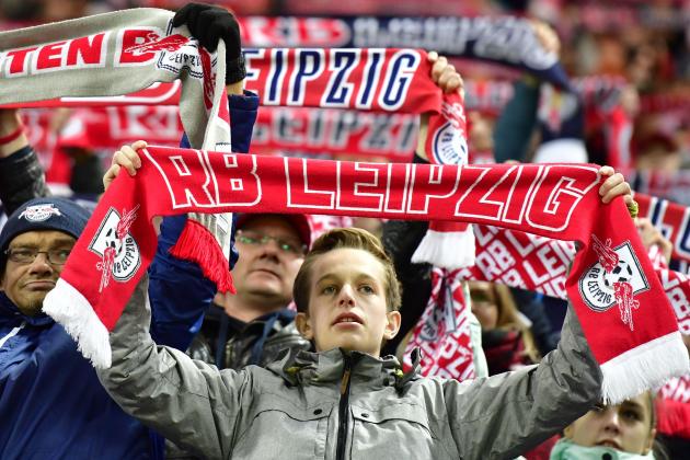 Leipzig's fans celebrate with football scarves after the German first division Bundesliga football match between RB Leipzig and Mainz 05 in Leipzig, eastern Germany, on November 6, 2016.  / AFP / John MACDOUGALL / RESTRICTIONS: DURING MATCH TIME: DFL RULES TO LIMIT THE ONLINE USAGE TO 15 PICTURES PER MATCH AND FORBID IMAGE SEQUENCES TO SIMULATE VIDEO. == RESTRICTED TO EDITORIAL USE == FOR FURTHER QUERIES PLEASE CONTACT DFL DIRECTLY AT + 49 69 650050
        (Photo credit should read JOHN MACDOUGALL/AFP/Getty Images)