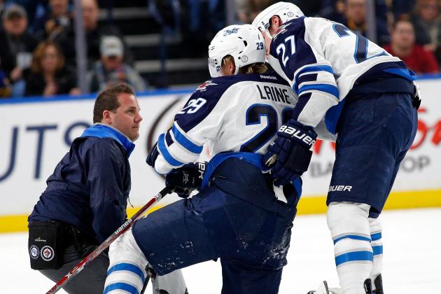 BUFFALO, NY - JANUARY 7: Patrik Laine #29 of the Winnipeg Jets is helped to the ice by Nikolaj Ehlers #27 and a trainer after being checked by Jake McCabe #29 of the Buffalo Sabres (not shown) during the third period at the KeyBank Center on January 7, 2017 in Buffalo, New York. Sabres beat the Jets 4-3. (Photo by Kevin Hoffman/Getty Images)