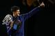 Novak Djokovic of Serbia waves as he walks around Rod Laver Arena after defeating Andy Murray of Britain in the men's singles final at the Australian Open tennis championships in Melbourne, Australia, Sunday, Jan. 31, 2016.(AP Photo/Rafiq Maqbool)