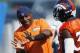 Denver Broncos defensive backs coach Joe Woods, left, gestures while speaking to cornerback Kayvon Webster during the team's NFL football training camp session early Thursday, Aug. 20, 2015, in Englewood, Colo. (AP Photo/David Zalubowski)