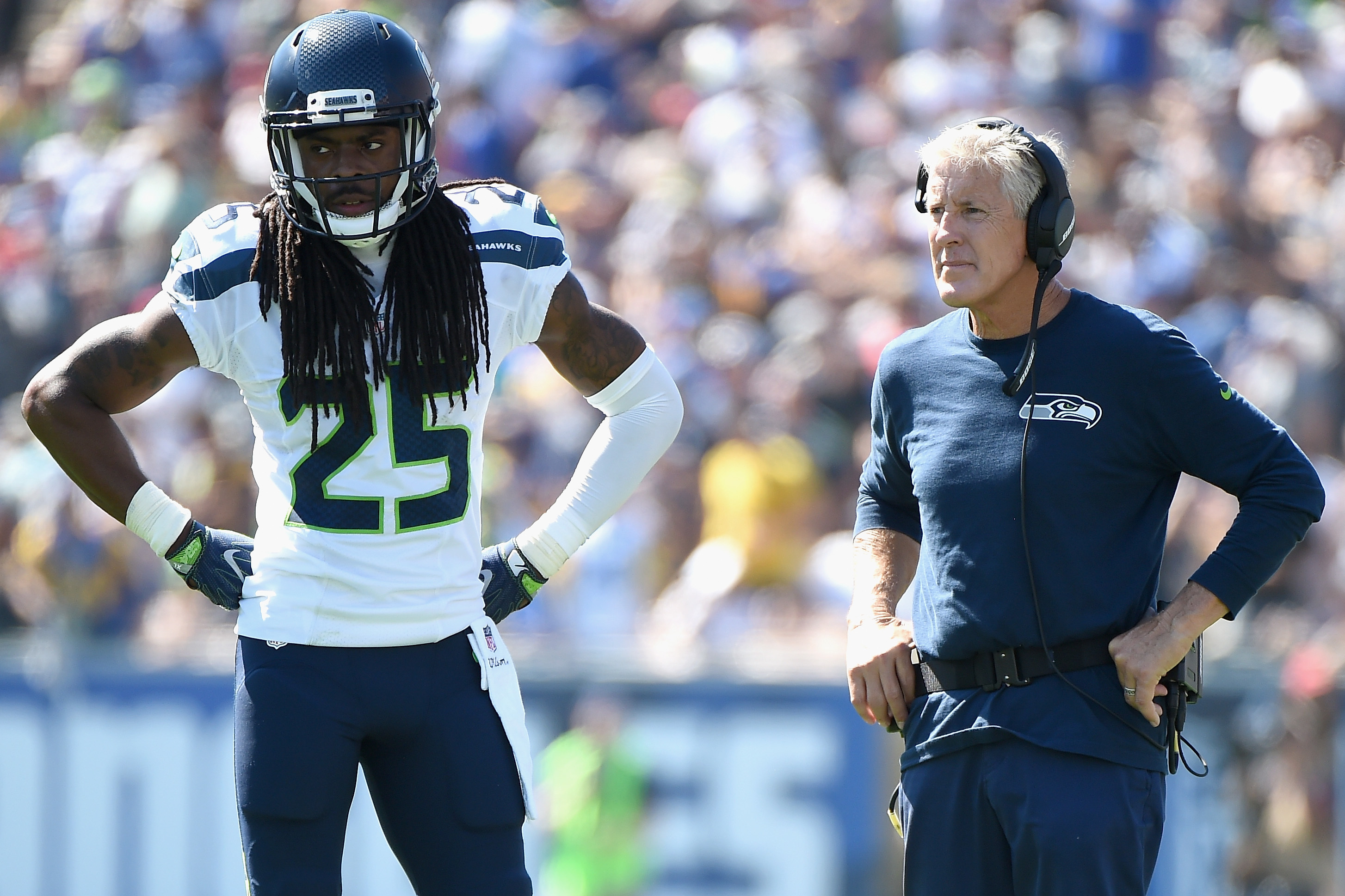 Seattle Seahawks head coach Pete Carroll talks things over with cornerback  Richard Sherman (25) while on the sidelines during the Super Bowl XLVIII at  MetLife Stadium in East Rutherford, New Jersey on