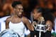 Runner up Venus Williams of the US (L) laughs with winner Serena Williams of the US during the awards ceremony following the women's singles final on day 13 of the Australian Open tennis tournament in Melbourne on January 28, 2017. / AFP / PAUL CROCK / IMAGE RESTRICTED TO EDITORIAL USE - STRICTLY NO COMMERCIAL USE (Photo credit should read PAUL CROCK/AFP/Getty Images)