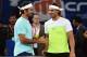 Spain's Rafael Nadal of the Indian Aces (R) and Switzerland's Roger Federer of the Japan Warriors greet each other during practice at the International Premier Tennis League (IPTL) event in New Delhi on December 12, 2015. AFP PHOTO / SAJJAD HUSSAIN / AFP / SAJJAD HUSSAIN (Photo credit should read SAJJAD HUSSAIN/AFP/Getty Images)