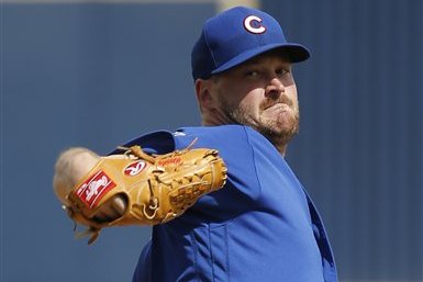 Chicago Cubs' Travis Wood throws before the first inning of a spring training baseball game against the Milwaukee Brewers Thursday, March 3, 2016, in Phoenix. (AP Photo/Morry Gash)
