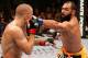 LAS VEGAS, NV - NOVEMBER 16: (R-L) Johny Hendricks punches Georges St-Pierre in their UFC welterweight championship bout during the UFC 167 event inside the MGM Grand Garden Arena on November 16, 2013 in Las Vegas, Nevada. (Photo by Josh Hedges/Zuffa LLC/Zuffa LLC via Getty Images)