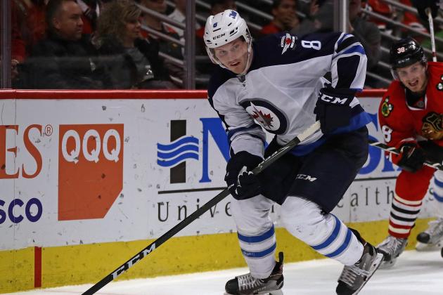 CHICAGO, IL - JANUARY 26: Jacob Trouba #8 of the Winnipeg Jets looks to pass the puck against the Chicago Blackhawks at the United Center on January 26, 2017 in Chicago, Illinois. The Jets defeated the Blackhawks 5-3. (Photo by Jonathan Daniel/Getty Images)