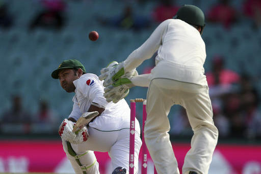 Pakistan's Sarfraz Ahmed, left, plays at the ball that goes past Australia's Peter Handscomb during their cricket test match in Sydney, Australia, Thursday, Jan. 5, 2017. (AP Photo/Rick Rycroft)