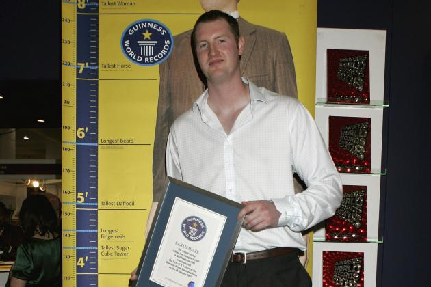LONDON - APRIL 16: Neil Fingleton, Britain's tallest man is presented with the Guinness World Record for being Britains tallest man at The London Book Fair on April 16, 2007 in London, England. Fingleton is 232.5 cms high or 7ft 7.56 inches. (Photo by Chris Jackson/Getty Images)