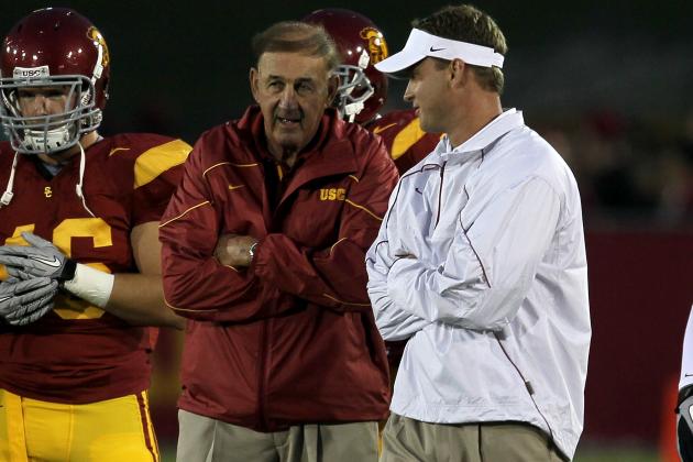 LOS ANGELES, CA - SEPTEMBER 11:  Head coach Lane Kiffin (R) and his father and defensive coordinator Monte Kiffin of the USC Trojans  talk during warmups for their game with the Virginia Cavaliers at Los Angeles Memorial Coliseum on September 11, 2010 in Los Angeles, California.  (Photo by Stephen Dunn/Getty Images)