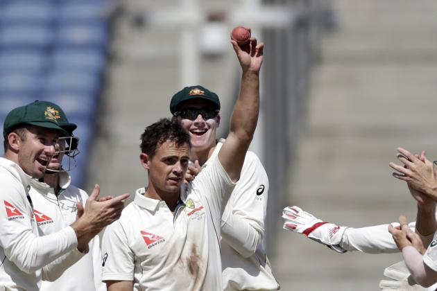 Australia's Steve O'Keefe, center, holds up the ball after his fifth wicket in the second innings of the first test cricket match against India in Pune, India, Saturday, Feb. 25, 2017. (AP Photo/Rajanish Kakade)