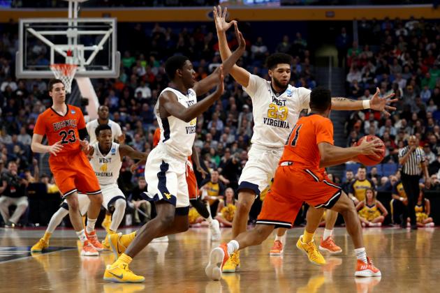 BUFFALO, NY - MARCH 16:  Lamont West #15 and Esa Ahmad #23 of the West Virginia Mountaineers defend Avi Toomer #11 of the Bucknell Bison in the first half during the first round of the 2017 NCAA Men's Basketball Tournament at KeyBank Center on March 16, 2017 in Buffalo, New York.  (Photo by Maddie Meyer/Getty Images)