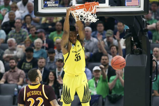 Oregon forward Kavell Bigby-Williams hangs on the rim after dunking as Iona forward Taylor Bessick, left, looks on during the first half of a first-round game in the men's NCAA college basketball tournament in Sacramento, Calif., Friday, March 17, 2017. (AP Photo/Steve Yeater)
