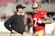 SANTA CLARA, CA - DECEMBER 28: Head coach Jim Harbaugh of the San Francisco 49ers talks with Colin Kaepernick #7 before their game against the Arizona Cardinals at Levi's Stadium on December 28, 2014 in Santa Clara, California. (Photo by Ezra Shaw/Getty Images)