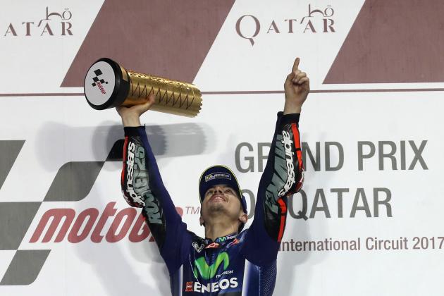 Champion Movistar Yamaha MotoGP's racers Maverick Vinales celebrates on the podium after winning the 2017 Qatar MotoGP at the Losail International Circuit, north of the capital Doha on March 26, 2017.
Spain's Maverick Vinales of Movistar Yamaha MotoGP won the season-opening Qatar MotoGP on March 26, 2017, shrugging off a poor start from pole position under the desert floodlights, with Italian Dovizioso coming in second on a Ducati and Rossi finishing third on a Honda. Defending world champion Marc Marquez was fourth on a Honda. / AFP PHOTO / Karim JAAFAR        (Photo credit should read KARIM JAAFAR/AFP/Getty Images)