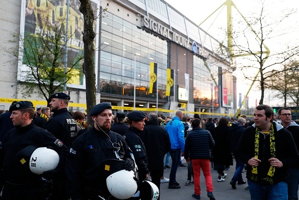 Police patrol outide the stadium after the team bus of Borussia Dortmund had some windows broken by an explosion some 10km away from the stadium prior to the UEFA Champions League 1st leg quarter-final football match BVB Borussia Dortmund v Monaco in Dortmund, western Germany on April 11, 2017. / AFP PHOTO / Odd ANDERSEN        (Photo credit should read ODD ANDERSEN/AFP/Getty Images)
