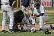 New York Yankees trainers and managers tend to Brett Gardner after Gardner collided with Tampa Bay Rays first baseman Rickie Weeks who was reaching for an errant throw during the sixth inning of a baseball game, Wednesday, April 12, 2017, in New York. (AP Photo/Julie Jacobson)