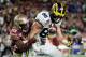 MIAMI GARDENS, FL - DECEMBER 30: Jake Butt #88 of the Michigan Wolverines completes a pass against the defense of A.J. Westbrook #19 of the Florida State Seminoles in the first half during the Capitol One Orange Bowl at Sun Life Stadium on December 30, 2016 in Miami Gardens, Florida. (Photo by Mike Ehrmann/Getty Images)