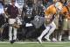 BRISTOL, TN - SEPTEMBER 10: Wide receiver Josh Smith #25 of the Tennessee Volunteers breaks the attempted tackle by safety Mook Reynolds #6 of the Virginia Tech Hokies in the second half at Bristol Motor Speedway on September 10, 2016 in Bristol, Tennessee. Tennessee defeated Virginia Tech 45-24. (Photo by Michael Shroyer/Getty Images)