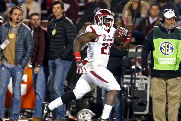 Arkansas running back Rawleigh Williams III (22) runs past Mississippi State fans on his way to a 72-yard touchdown sprint during the first half of an NCAA college football game against in Starkville, Miss., Saturday, Nov. 19, 2016. (AP Photo/Rogelio V. Solis)