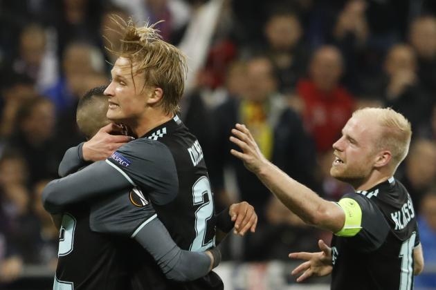 Ajax's Kasper Dolberg is hugged by Ajax's Hakim Ziyech, left, and Ajax's Davy Klaassen after Dolberg scored his side's first goal during the second leg semi final soccer match between Olympique Lyon and Ajax in the Stade de Lyon, Decines, France, Thursday, May 11, 2017. (AP Photo/Laurent Cipriani)