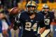 PITTSBURGH, PA - OCTOBER 16: James Conner #24 of the Pittsburgh Panthers tosses the ball against the Virginia Tech Hokies during the game at Heinz Field on October 16, 2014 in Pittsburgh, Pennsylvania. The Panthers won 21-16. (Photo by Matt Kincaid/Getty Images)