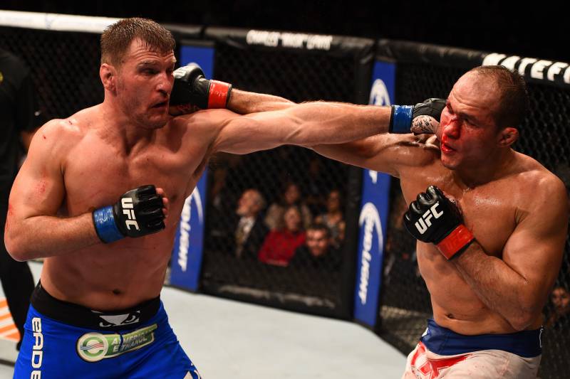 PHOENIX, AZ - DECEMBER 13: (R-L) Junior Dos Santos of Brazil and Stipe Miocic trade punches in their heavyweight fight during the UFC Fight Night event at the U.S. Airways Center on December 13, 2014 in Phoenix, Arizona. (Photo by Josh Hedges/Zuffa LLC/Zuffa LLC via Getty Images)