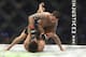 Frankie Edgar, top, fights Yair Rodriguez in a mixed martial arts bout at UFC 211 on Saturday, May 13, 2017, in Dallas. Edgar won by doctor stoppage after round 2. (AP Photo/Gregory Payan)