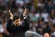 Tottenham Hotspur's Argentinian head coach Mauricio Pochettino gestures in the rain during the closing ceremony at White Hart Lane in London, on May 14, 2017.
Tottenham Hotspur legends including Glenn Hoddle and Ossie Ardiles took part in an on-pitch ceremony as the club said goodbye to their White Hart Lane stadium on Sunday. / AFP PHOTO / Ben STANSALL / RESTRICTED TO EDITORIAL USE. No use with unauthorized audio, video, data, fixture lists, club/league logos or 'live' services. Online in-match use limited to 45 images, no video emulation. No use in betting, games or single club/league/player publications. (Photo credit should read BEN STANSALL/AFP/Getty Images)