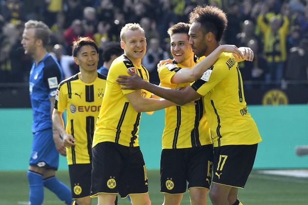 Dortmund's Pierre-Emerick Aubameyang, right, is celebrated by Dortmund's Sebastian Rode and Dortmund's Raphael Guerreiro after scoring during the German Bundesliga soccer match between Borussia Dortmund and TSG Hoffenheim in Dortmund, Germany, Saturday, May 6, 2017. Dortmund defeated Hoffenheim with 2-1. (AP Photo/Martin Meissner)